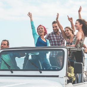 friends in a jeep by the ocean