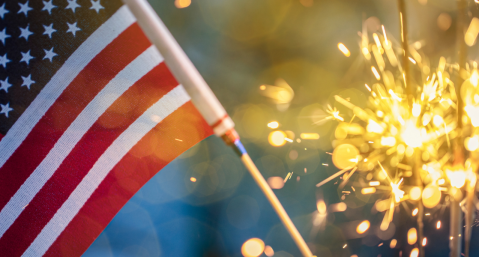 closeup of a US flag and sparkler