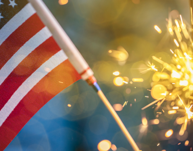 closeup of a US flag and sparkler