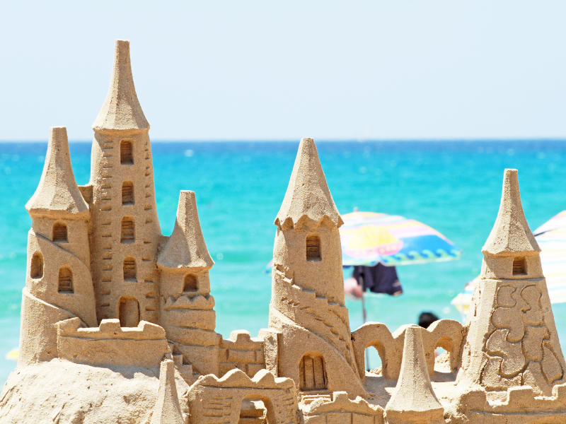 sandcastle with ocean in background