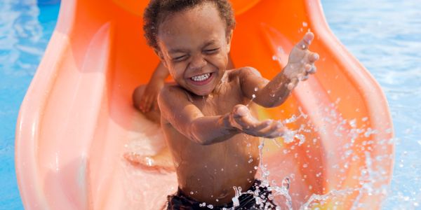little boy on water slide