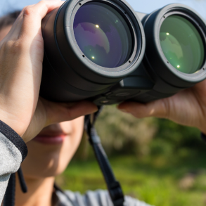 person looking through binoculars