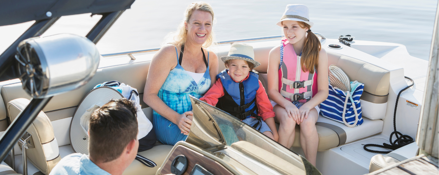 family with two children on a boat