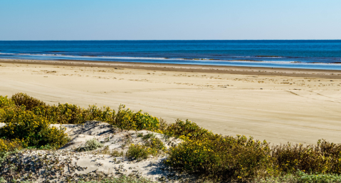 wide open beach with beautiful blue water