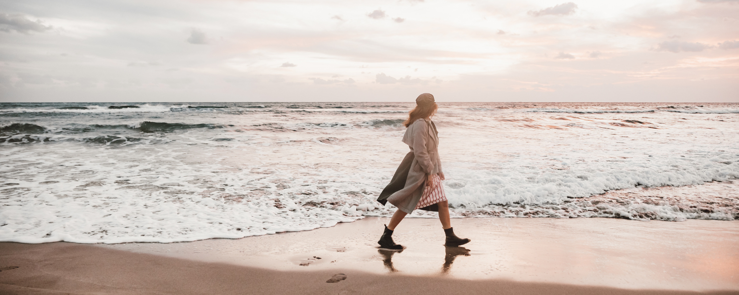 woman walking along shoreline