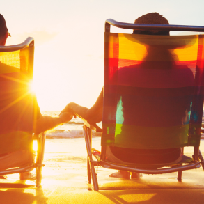 couple sitting in chairs on beach