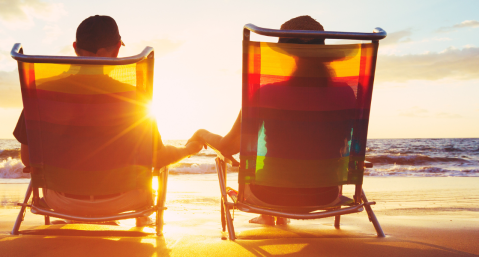 couple sitting in chairs on beach