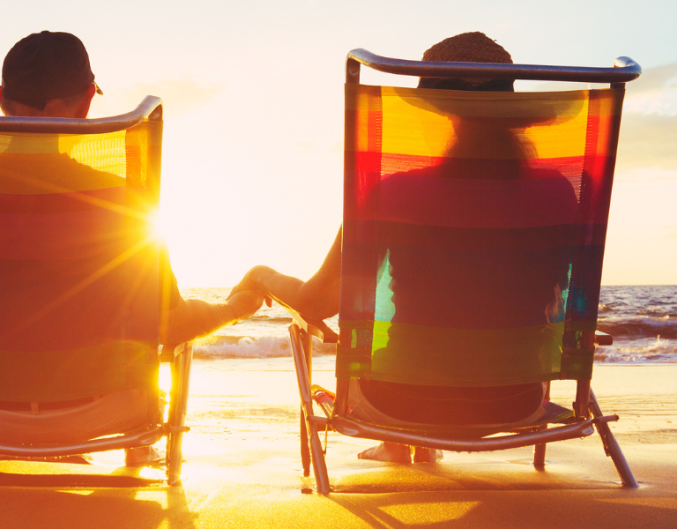 couple sitting in chairs on beach