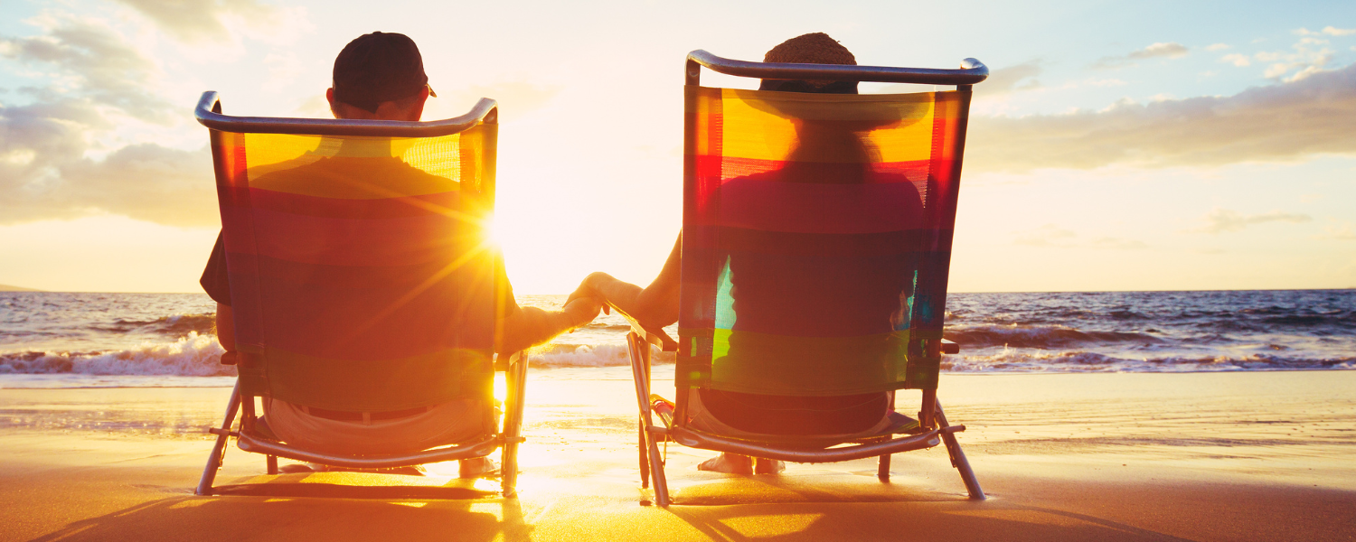 couple sitting in chairs on beach