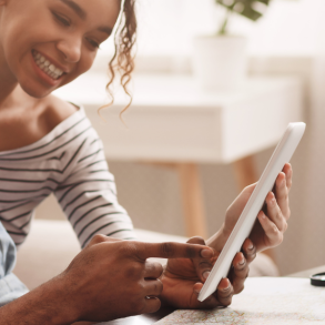 couple look at iPad planning vacation