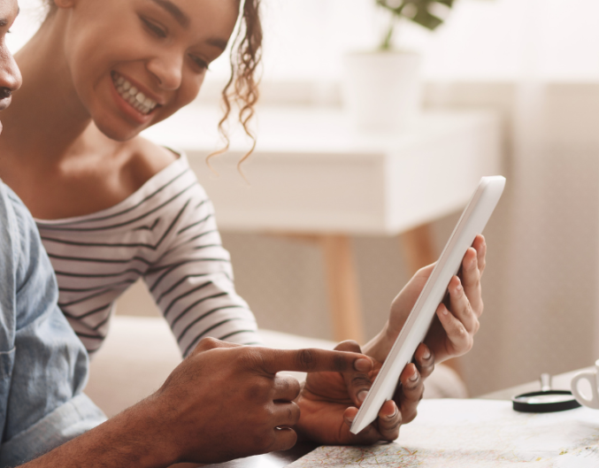 couple look at iPad planning vacation